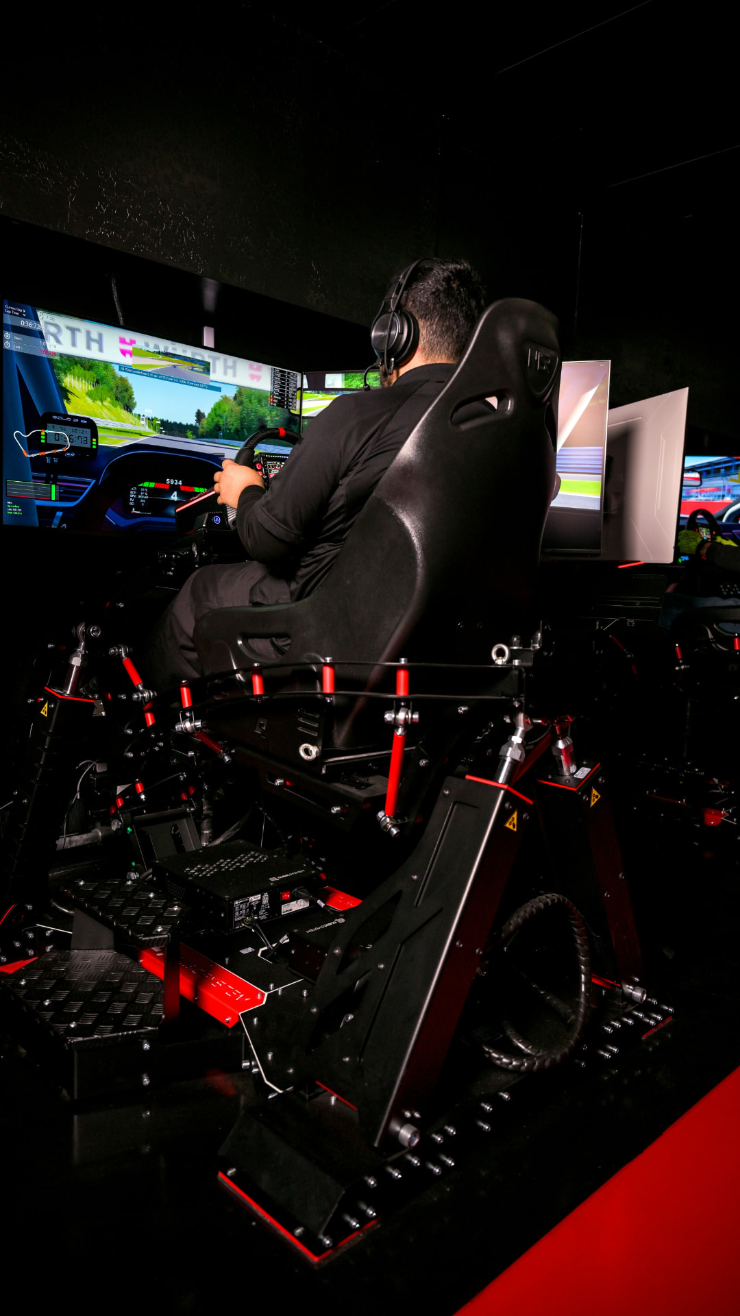 A young driver training in a professional racing simulator